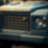 A close-up view of the square Land Rover's iconic front grille and headlights